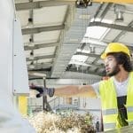 Workers use Business central to improve manufacturing using Business Central For Manufacturing