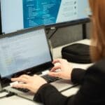 CRM software for marketing Akita CRM specialist working on laptop
