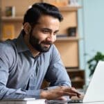 Dynamics 365 Evolution Man working on computer receiving Dynamics 365 support