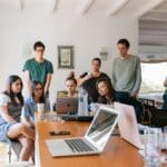 small business erp employees working together on a laptop