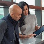 Man and lady looking at service management module on ipad